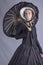 Victorian woman in black ensemble with parasol