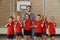 Victorious School Sports Team With Medals And Trophy In Gym