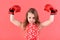 Victory, champion, winner. Kid boxer with long hair on red background.