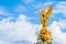 Victory Goddess golden statue on top of the Victoria Memorial located in front of Buckingham Palace with empty sky background for