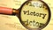 Victory - magnifying glass enlarging English word Victory to symbolize taking a closer look, analyzing or searching for an