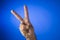 Victory sign on blue background