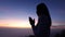 Video 4k  Slow motion,  Silhouette of woman Praying hands with faith in religion and belief in God On the morning sunrise
