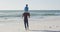 Video of african american father carrying son on arms and walking on beach