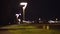 Video background of an empty jogging path with street lights near a highway