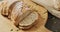 Video of bread on chopping wooden board on wooden worktop