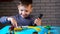 Video call of four year old kid playing with small cars