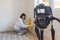 Video camera filming how  clever woman cleaning mold from wall using spray bottle