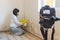 Video camera filming how woman cleaning mold from wall using spray bottle with mildew removal products