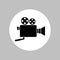 Video camera round icon. Black silhouette in white circle. Isolated vector symbol.