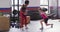 Video of caucasian woman exercising in gym with weights and with biracial female coach