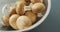 Video of close up of bowl of fresh mushrooms on grey background