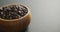 Video of close up of wooden bowl of chocolate chip over grey background