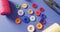 Video of colourful buttons with thread snippers and reels of cotton on blue background