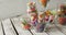 Video of colourful various sweets in glass vessels on wooden table