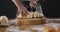 Video of cook cuts the loaf of bread on black background