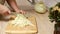 Video cropped housewife hands cutting and splitting cabbage head with sharp knife on wooden chopping board on table