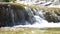 Video of crystal clear water running in mountain forest stream. Small drops of water splashing, sunny summer day