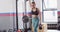 Video of determined caucasian woman working out with kettlebell weights at gym