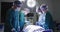 Video of diverse group of surgeons operating on patient in operating theatre