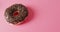 Video of donut with icing on pink background