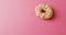 Video of donut with icing on pink background