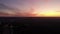 Video with the drone over the city at sunset, Plane flying in the background