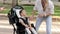 Video of enjoy happy love family mother walking outdoors and carer helping look at disabled son child sitting in