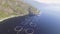 Video of Fish Farm in Norway. Blue sea and mountains with vegetation. Aerial shot. Top view.