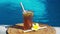 Video footage of glass with iced tea, cold with ice cubes and slices of lime, bamboo straw