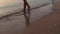 Video footage ,Woman legs on the beach sand waves sea at sunrise