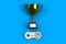 Video game console GamePad. Gaming concept. Top view retro joystick with trophy isolated on blue background