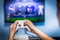 Video gaming and game play on tv fun gamer holding game-pad and controller video console playing and enjoying with blurred screen