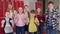 Video of group of smiling children standing in the school corridor.