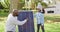 Video of happy african american father explaining solar panel to daughter in autumn garden