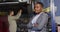 Video of happy african american female car repair shop owner looking at camera