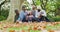 Video of happy african american parents and daughter sitting with grandparents in autumn garden