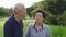 Video of Happy asian senior couple pointing, talking and walk through the park with nature background