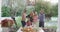 Video of happy caucasian parents, daughter and grandparents taking selfie at outdoor family dinner
