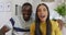 Video of happy diverse couple making video call smiling and waving to camera in kitchen