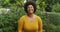 Video of happy plus size african american woman standing in garden