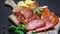 Video of italian meat plate - sliced prosciutto, sausage and cheese