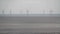 Video, large farm  of wind turbines in sea.