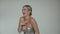 Video laughing, humorous, coquettish blond woman in silver cocktail dress with golden accessories waving hands on party