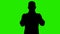 Video of man`s silhouette wearing medical mask on green background