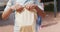 Video midsection of african american schoolboy holding packed lunch outside school