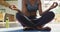 Video of midsection of african american woman practicing yoga at home