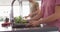 Video of midsection of diverse couple preparing vegetables for cooking