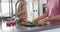 Video of midsection of diverse couple preparing vegetables for cooking