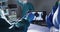 Video of midsection of two gloved surgeons discussing x-ray on tablet in operating theatre